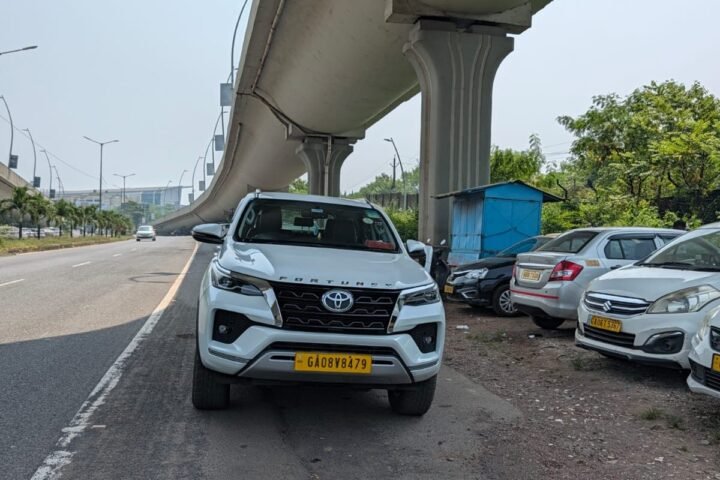 White Toyota Fortuner tourist taxi parked under the flyover near Dabolim Goa Airport