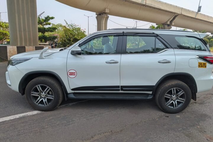 Side view of the white Toyota Fortuner tourist vehicle with Goa yellow number plate